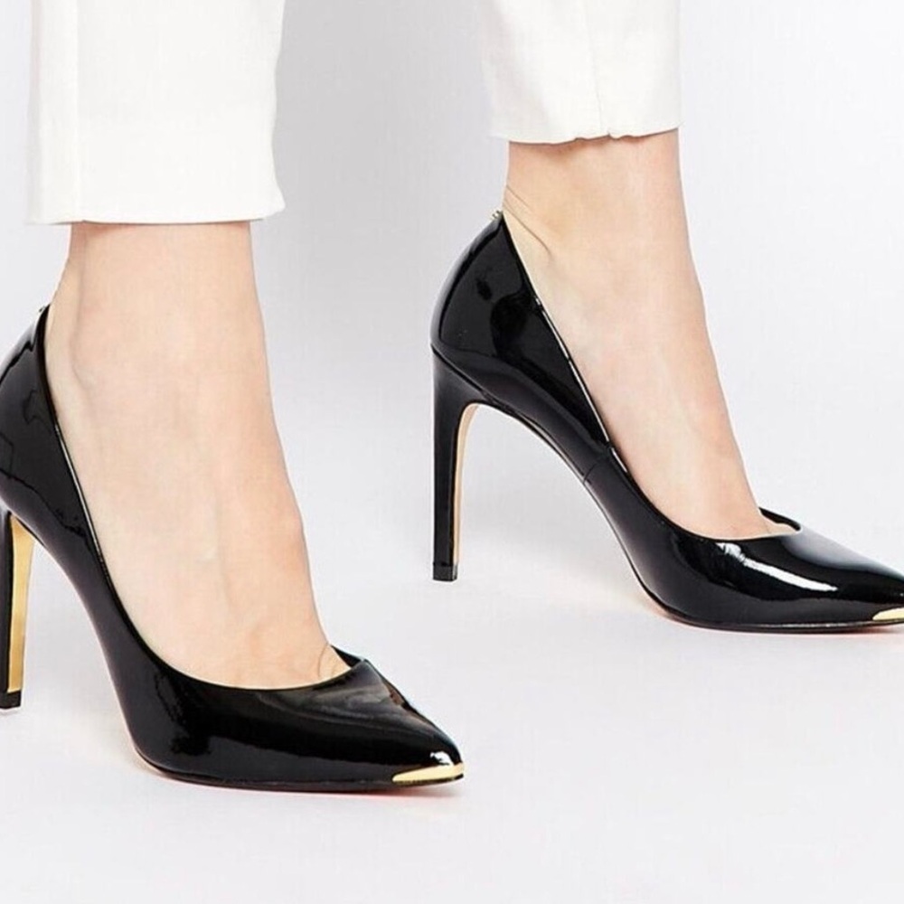 Ted Baker Woman’s Neevo patent leather pointy toe heel; gold accents.